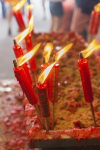 burning red chinese candle in temple