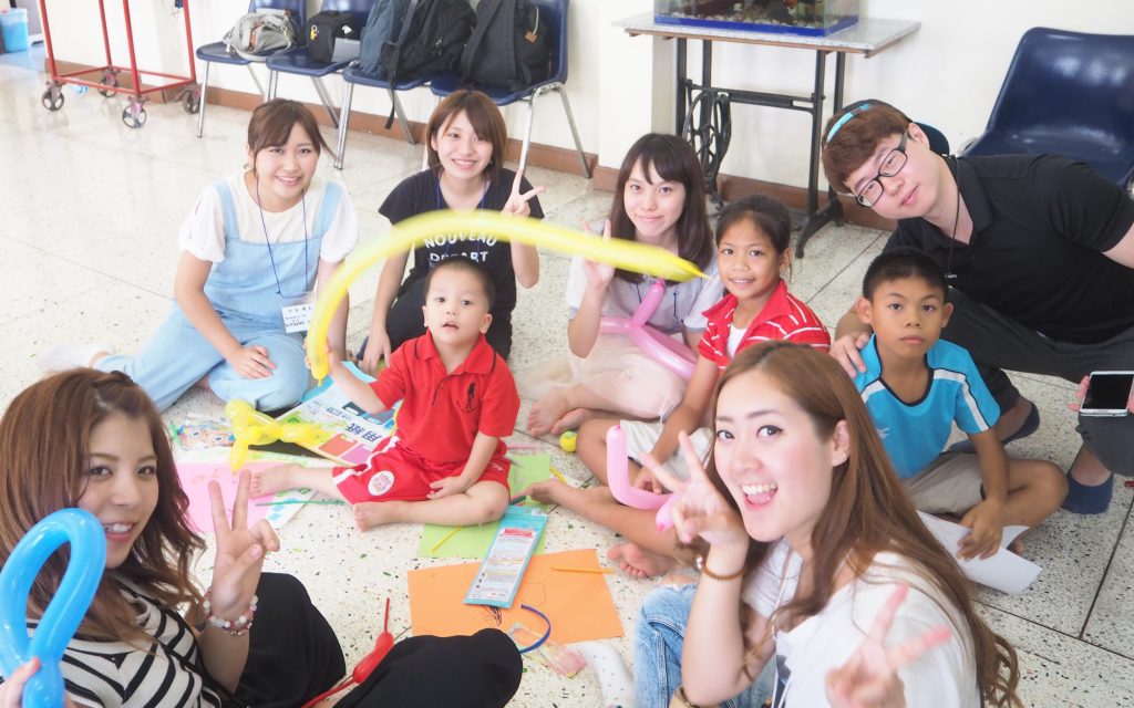 Assumption University students accompany visiting Japanese students to a Thai orphanage.